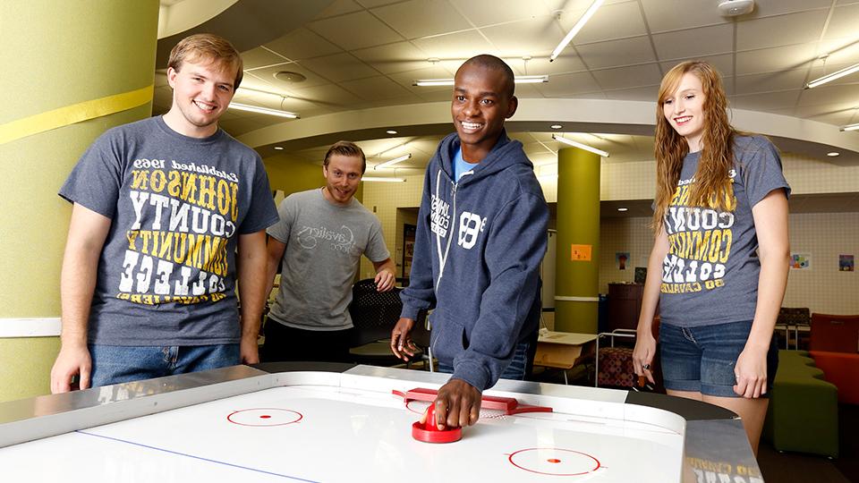 Students playing air hockey in the Student Lounge